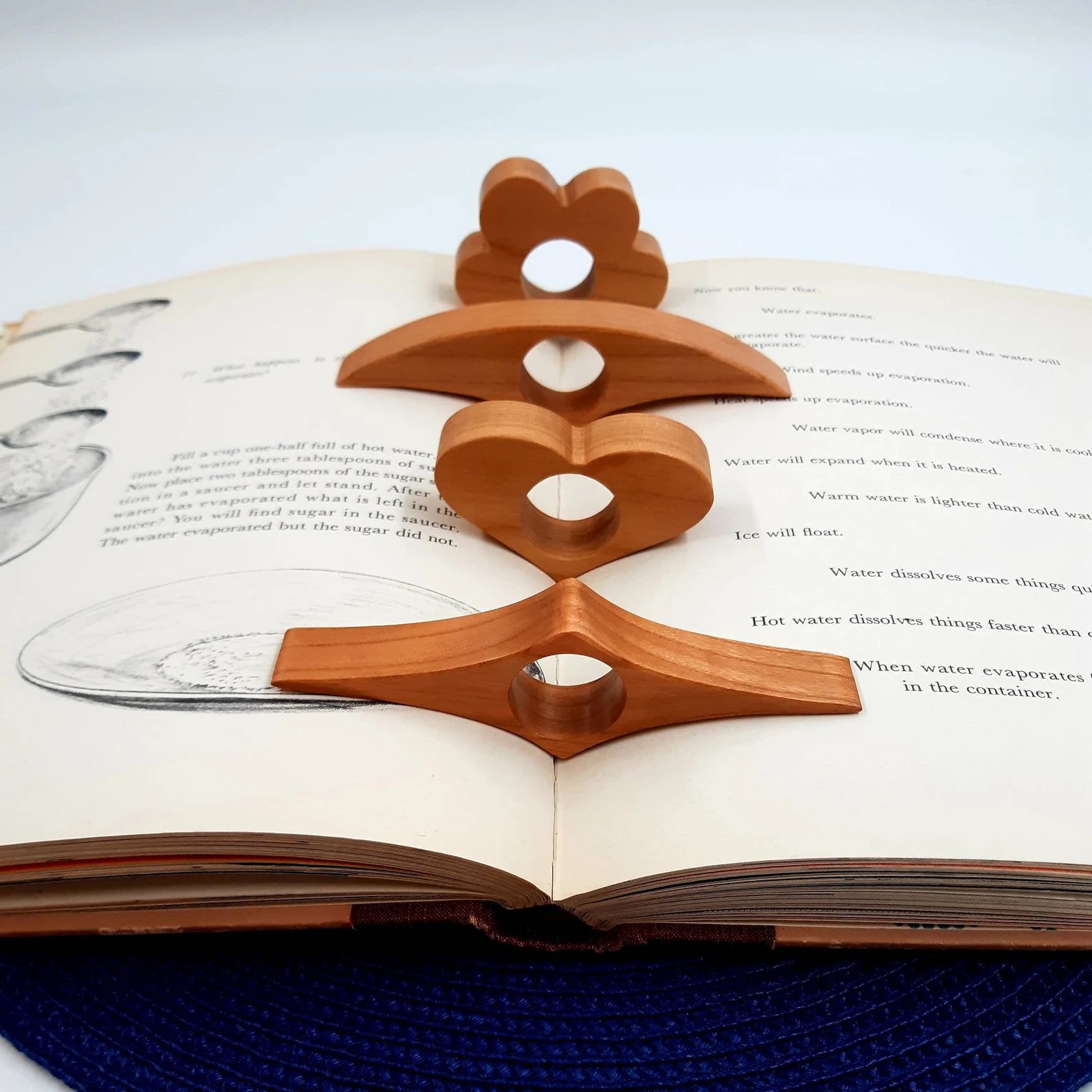 a photo of a wooden thumb hold that helps readers keep books open