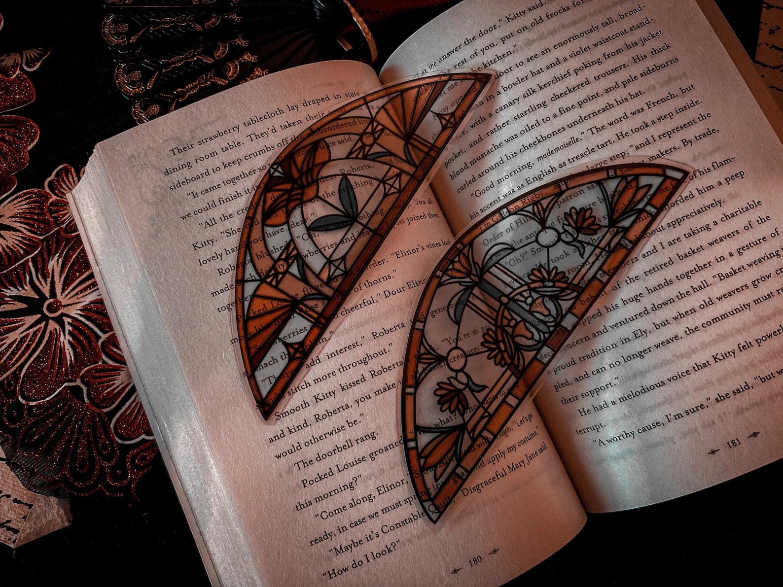 a photo of two stained glass bookmarks sitting on an open book