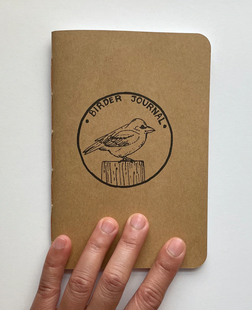 Small brown journal with bird stamp on cover