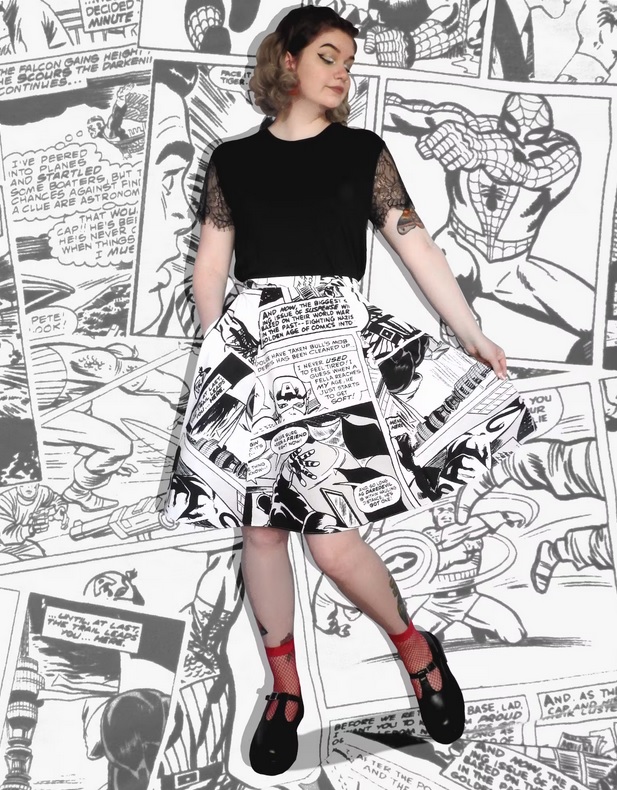 A woman poses in a knee-length skirt covered in black-and-white panels from Marvel comics