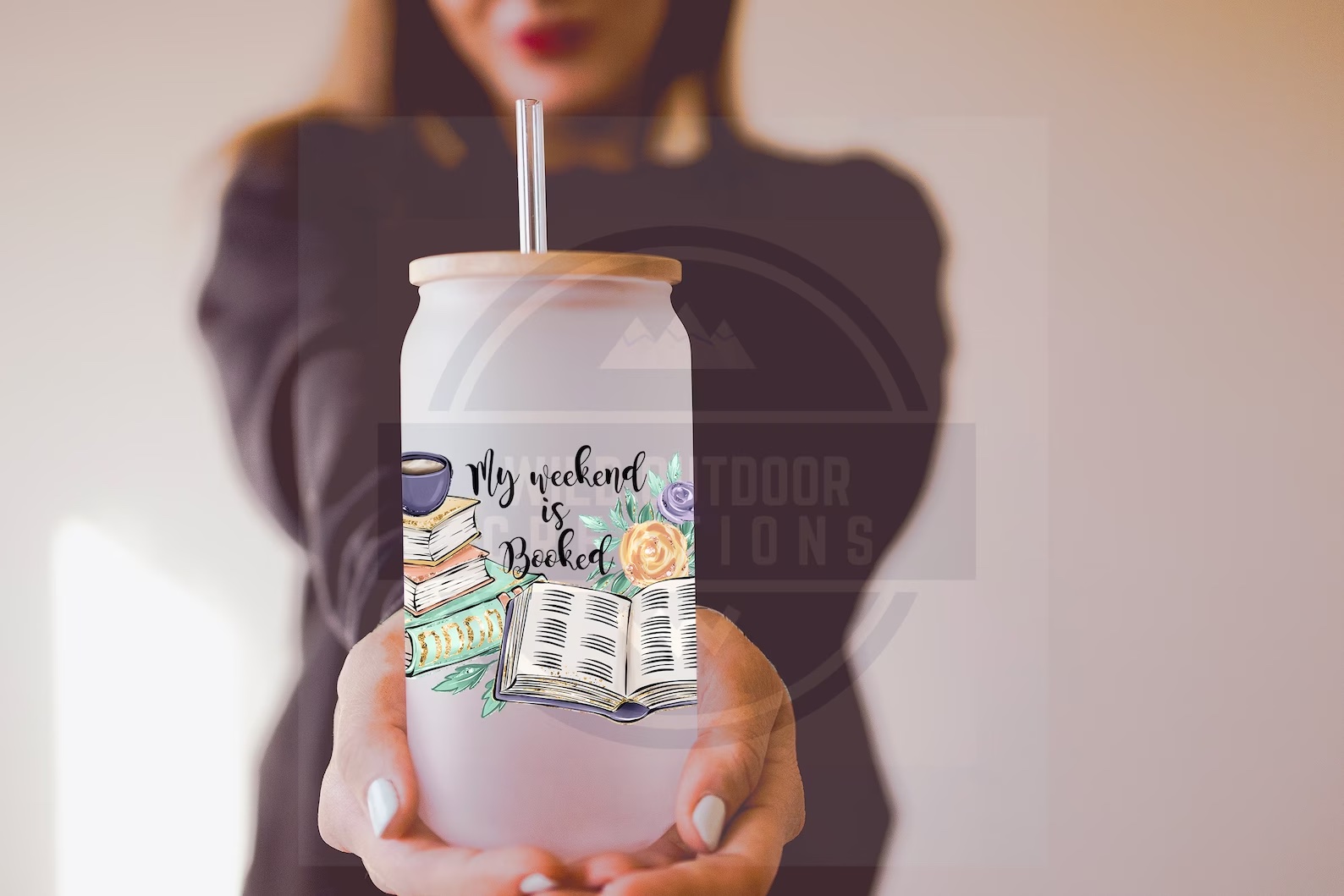 a photo of a white woman holding out a glass that is beautifully decorated with illustrations of flowers. The text on the glass reads, "My Weekend Is All Booked"