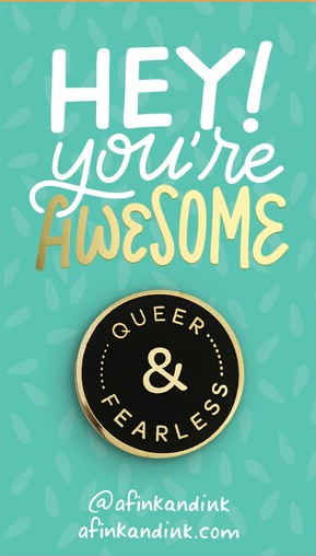 photo of a queer and fearless round black enamel pin