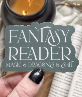 a photo of a sticker that says "Fantasy reader: magic & dragons & shit"