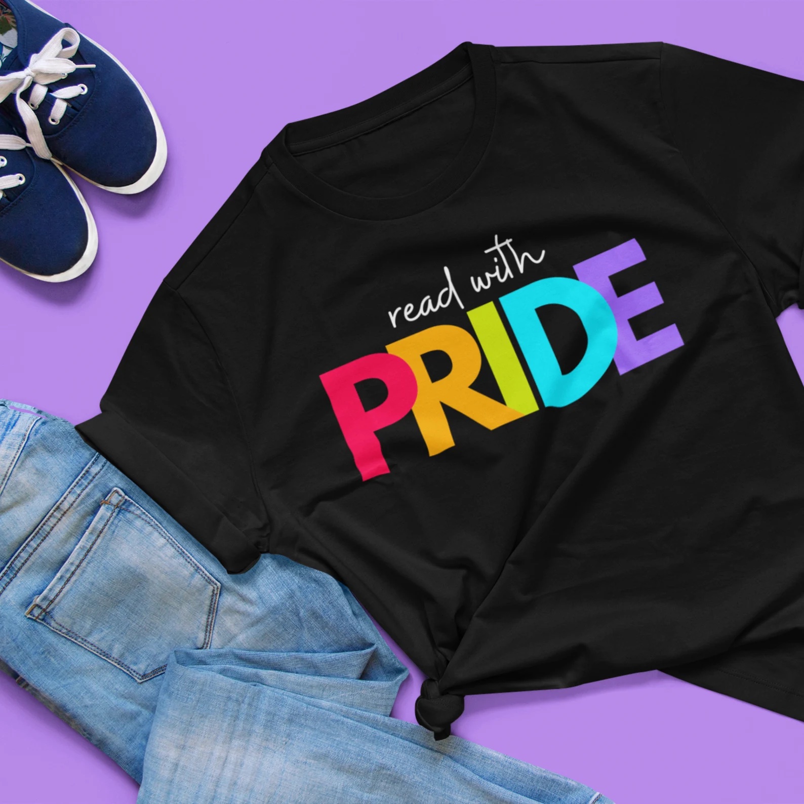 a photo of a black t-shirt that says, "read with pride." "Pride" is in rainbow letters.