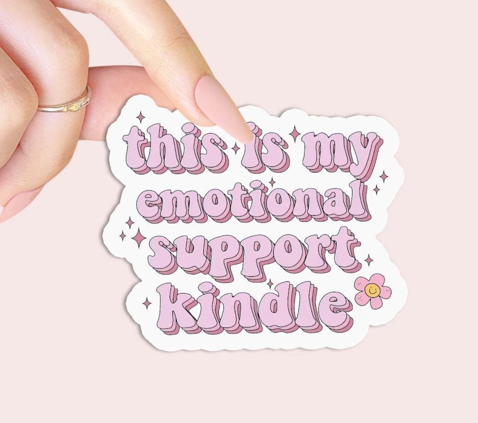 a graphic depicting a sticker in pink font that read "this is my emotional support kindle"