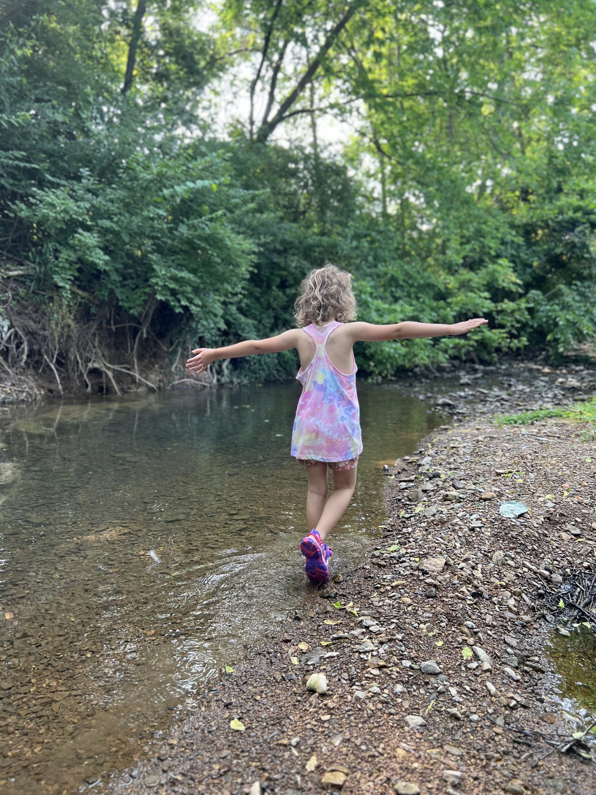 Marian playing in a creek, the kids are all right