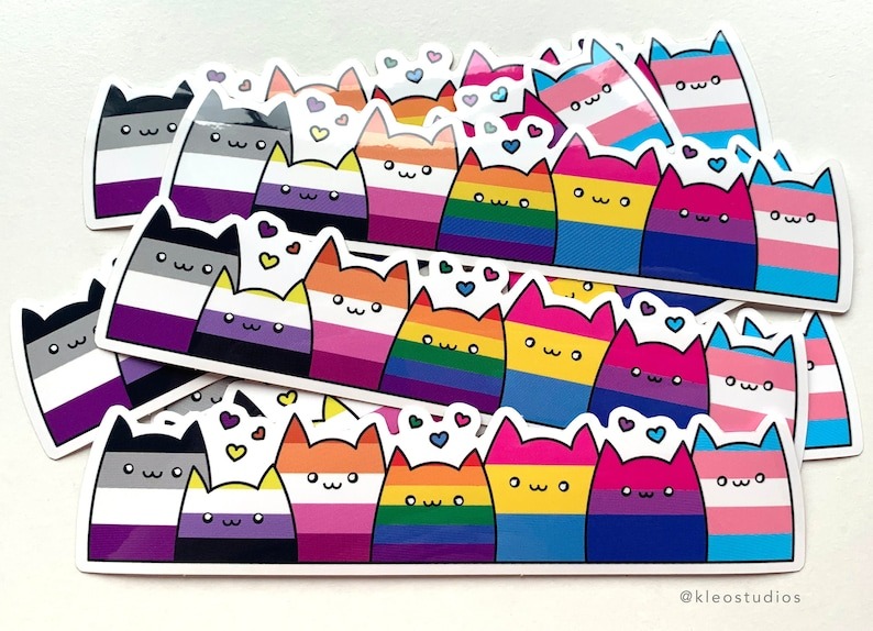 a sticker of cats in pride flag colors