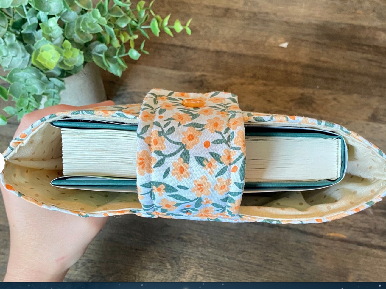 Floral fabric book sleeve containing book