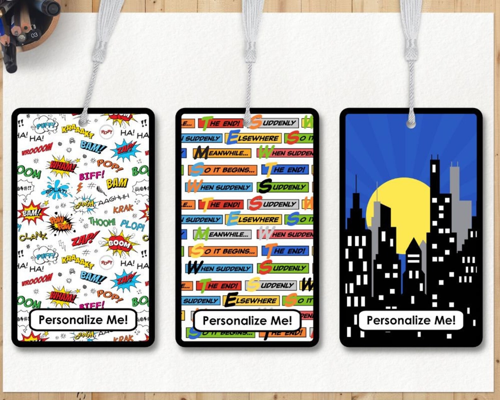 Three bookmarks: one with onomatopoeias, one with comic-style narration boxes, and one with a city skyline at night 