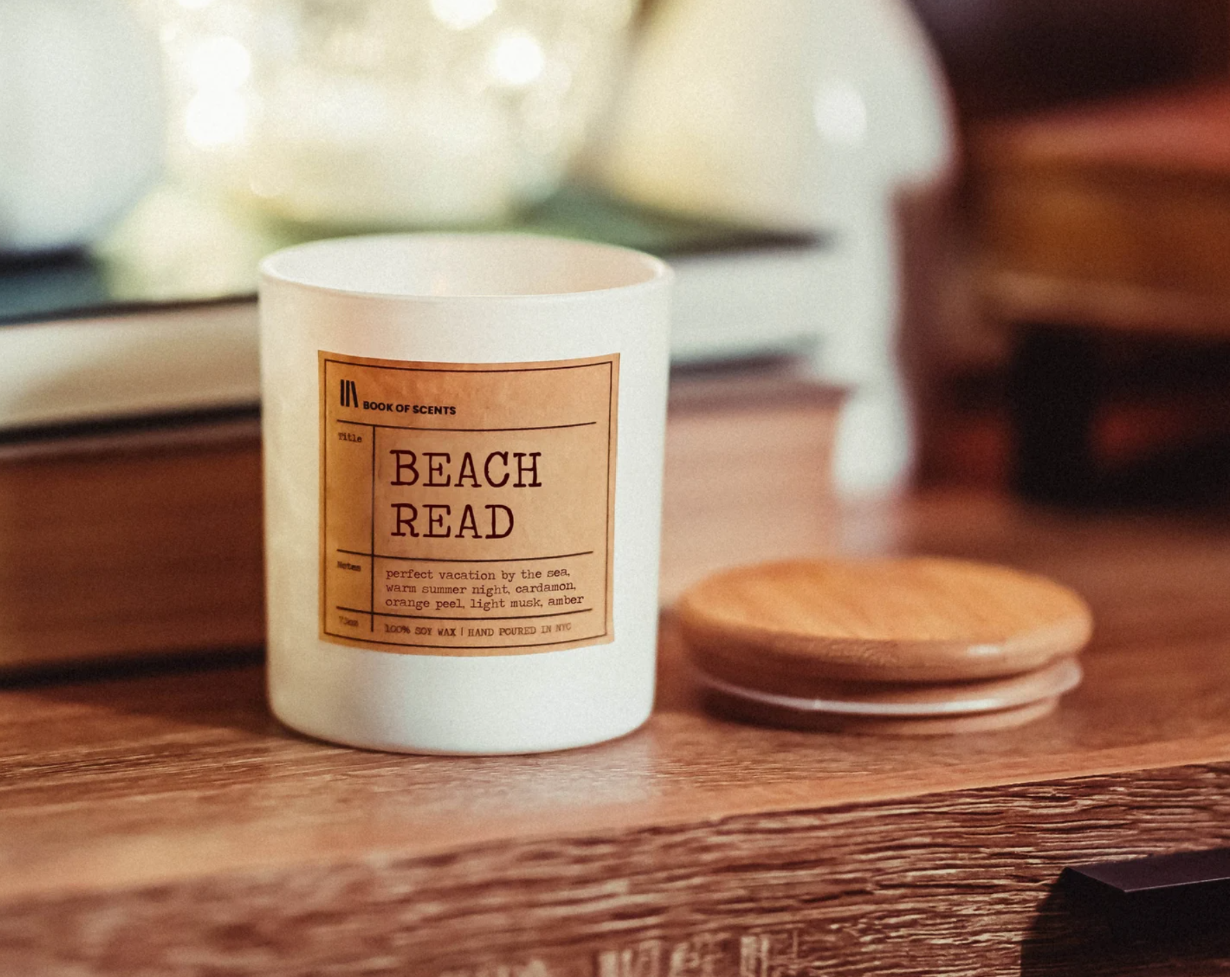Beach Read Candle in a white ceramic container with a wooden lid