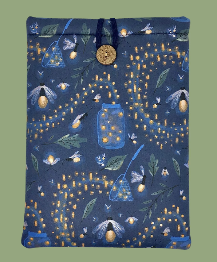 a photo of a fabric book protector with a fireflies print