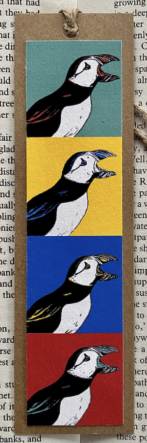 a bookmark made of four stacked art prints in pop art style with puffins