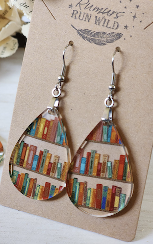 clear teardrop shaped danging earrings with shelves of books painted inside