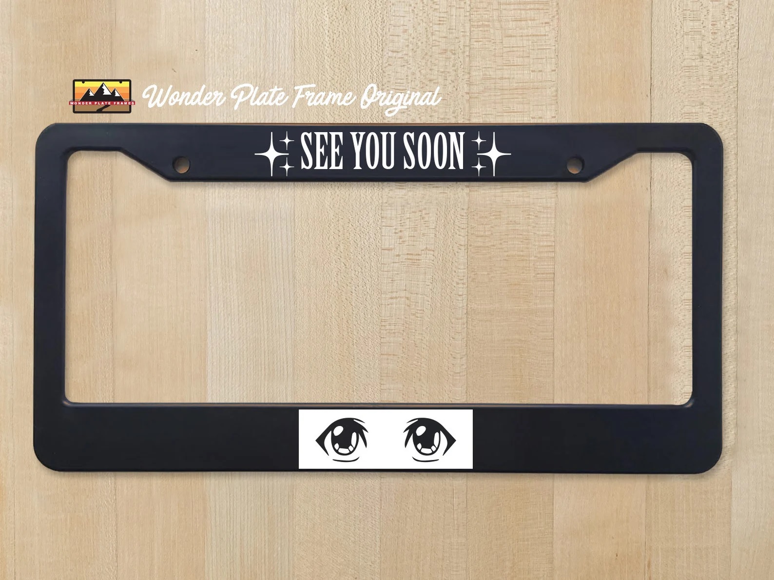 A black license plate frame with the words "see you soon!" on top and an anime girl's eyes on the bottom