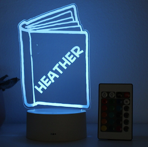 a standing night light shaped like a book with the name Heather personalized on the cover