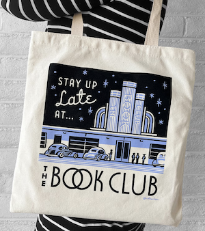 a tote bag with a screen print image of a 1950s club with cars that says "stay up late at the book club"