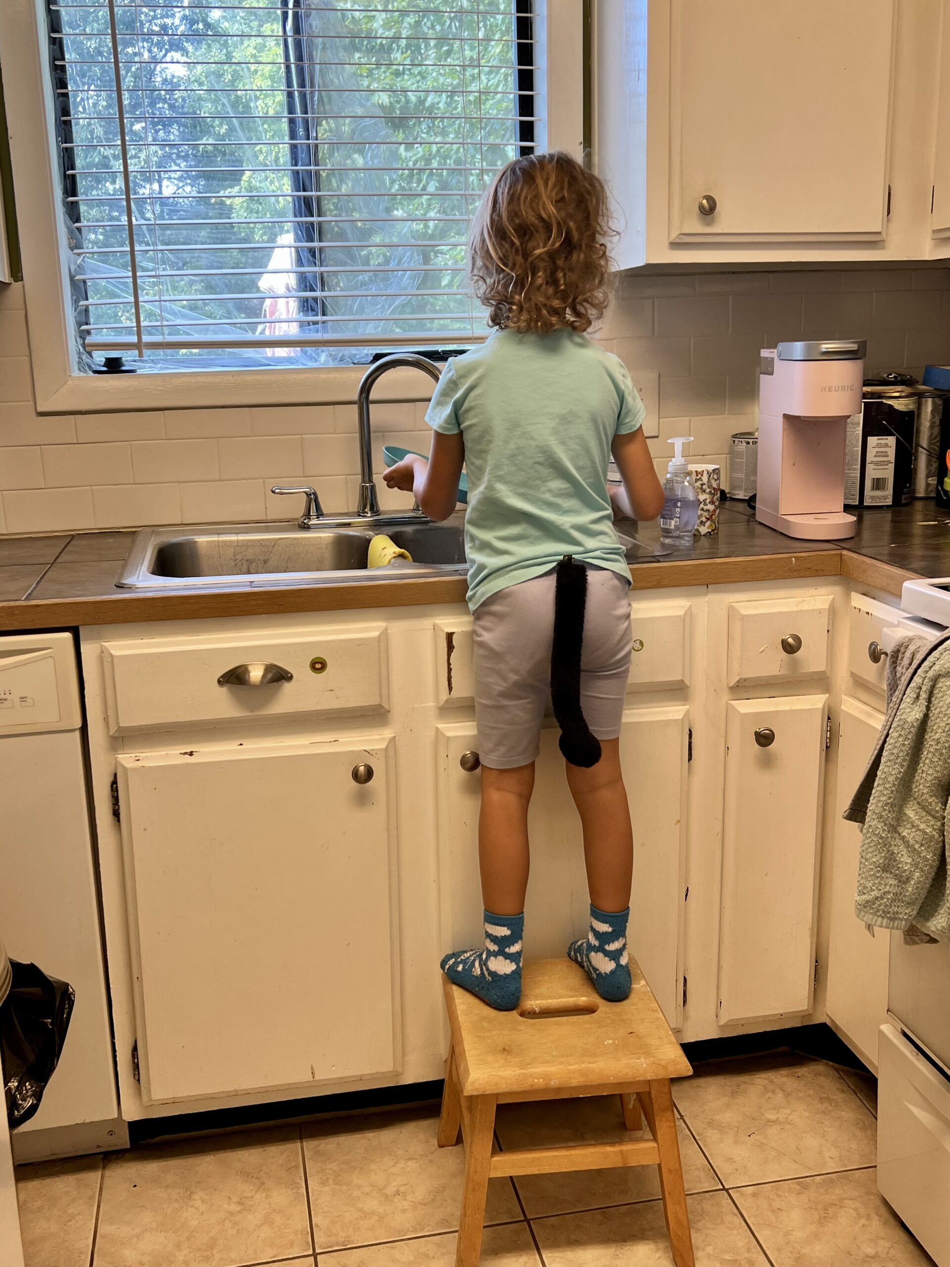 Marian as a cat washing dishes, the kids are all right