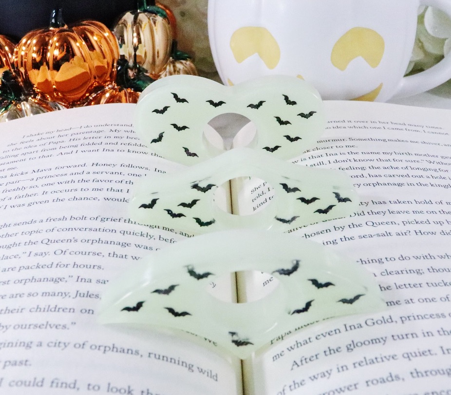 image of three book page holders that glow in the dark and are covered in bats.