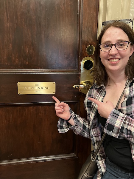 Katie points excitedly at the plaque outside the Stephen King Suite at the Stanley Hotel