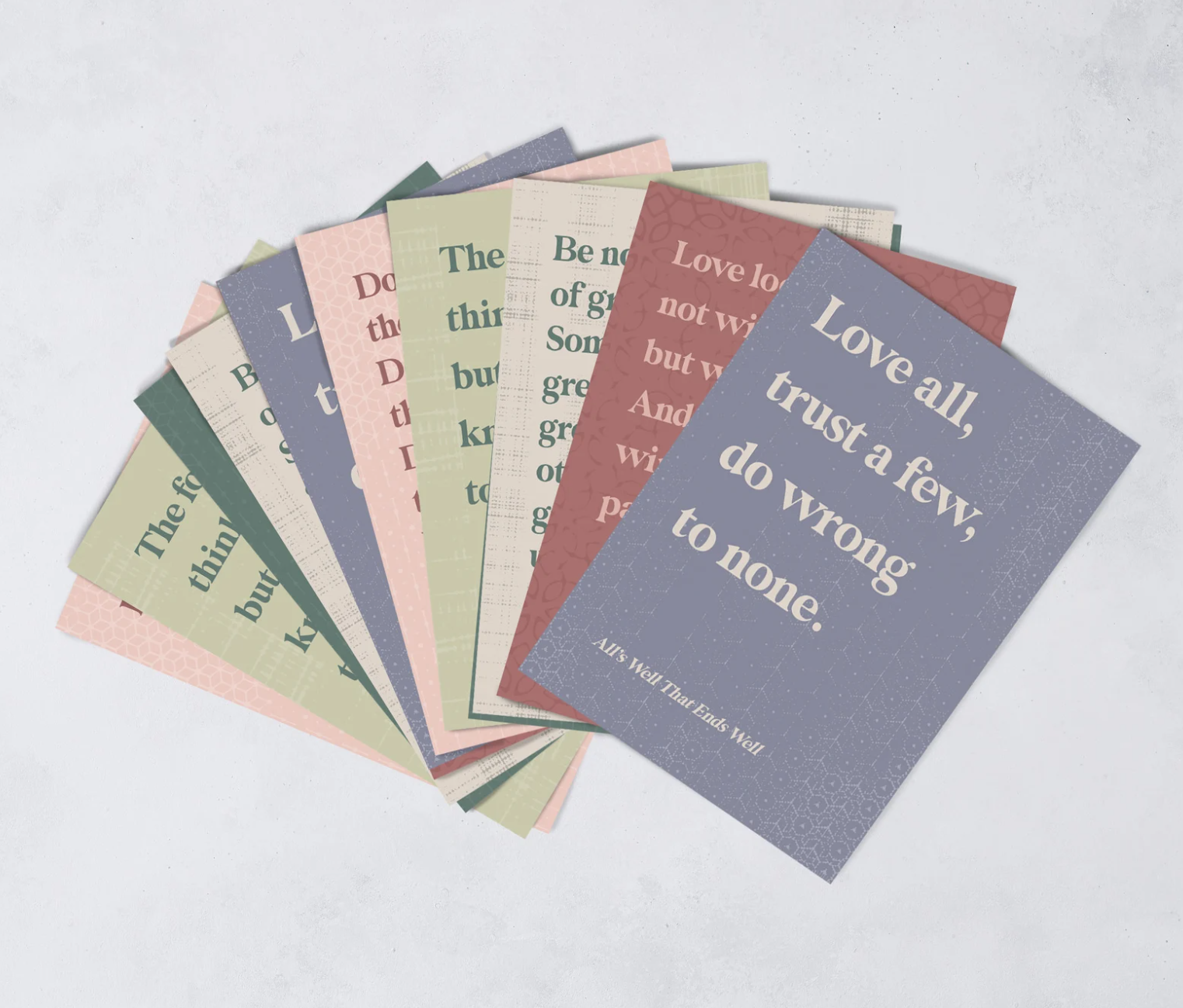 A spread of colorful Shakespeare postcards featuring large quotes from Shakespeare. 