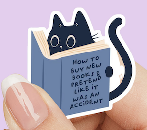 sticker of cat reading book with title that says "how to buy new books & pretend like it was an accident"