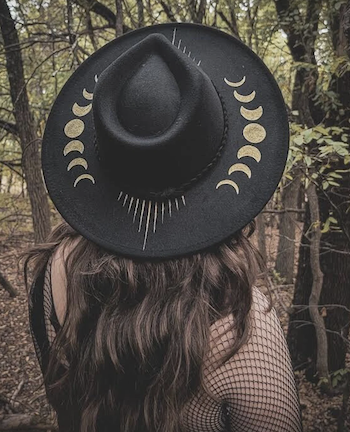 a photo of a wide-brimmed hat with phases on the moon painted on the brim