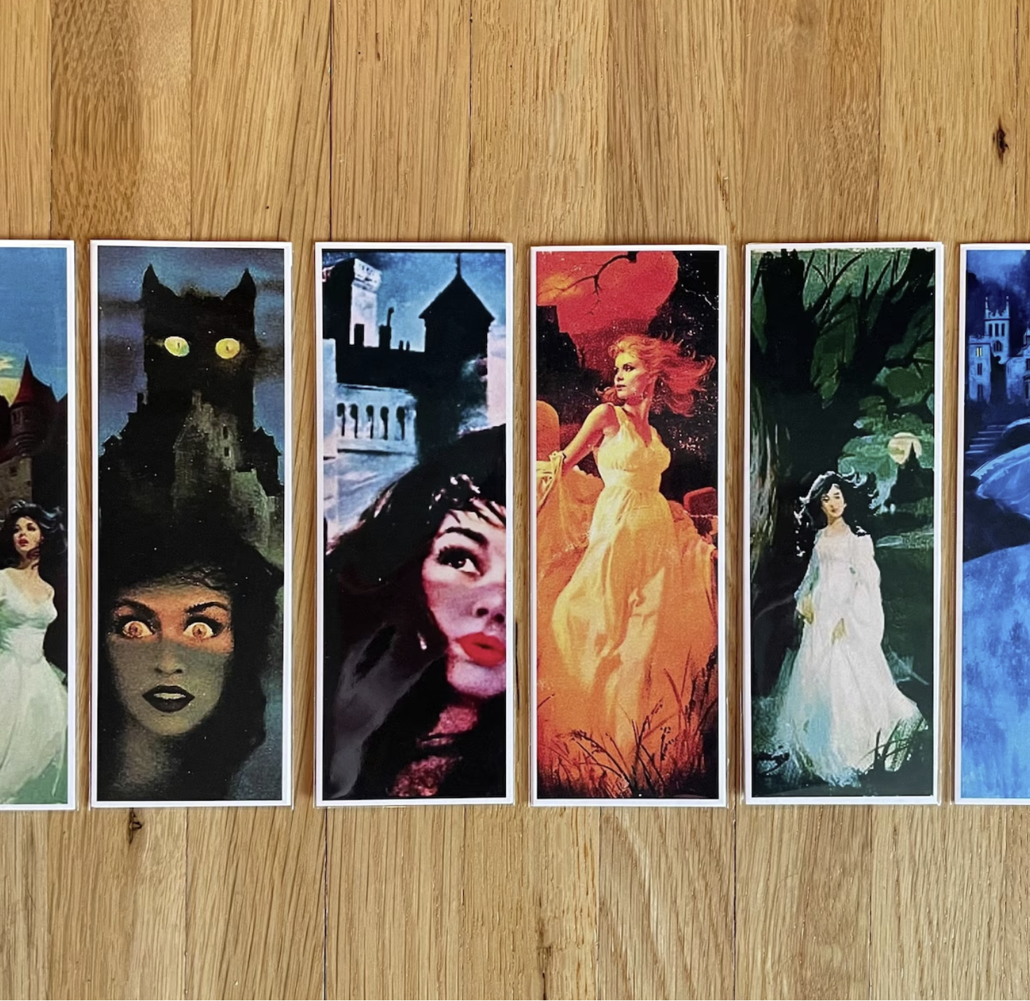 6 bookmarks featuring heroines from vintage gothic romance novels against a light wood background.