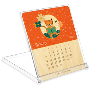 a wood calendar for the month of January 2024 with an illustration of a tiger reading a book