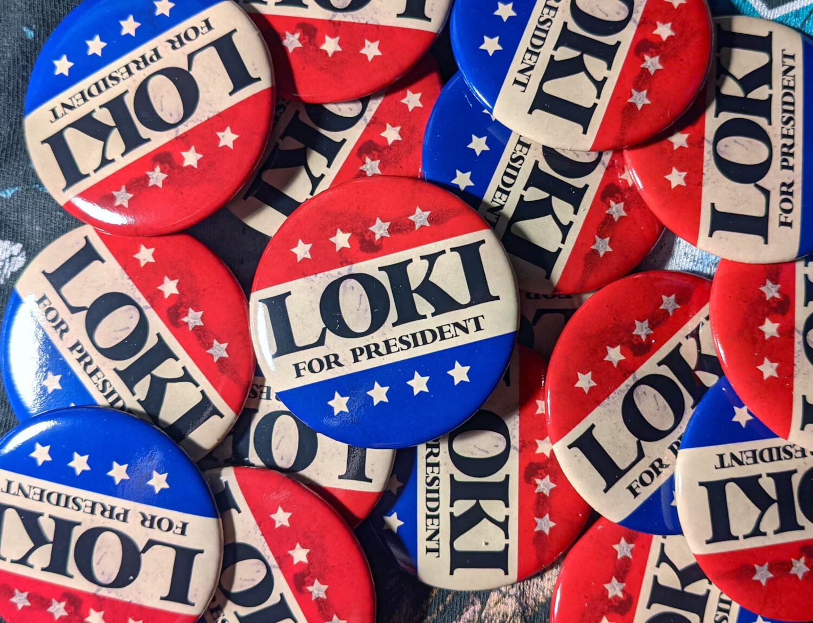 A pile of red, white, and blue campaign buttons that say "Loki for President"