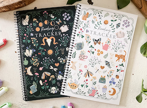 the cover of two reading tracker journals which have graphic doodles of cats, butterflies, books on one and skulls and books on the other