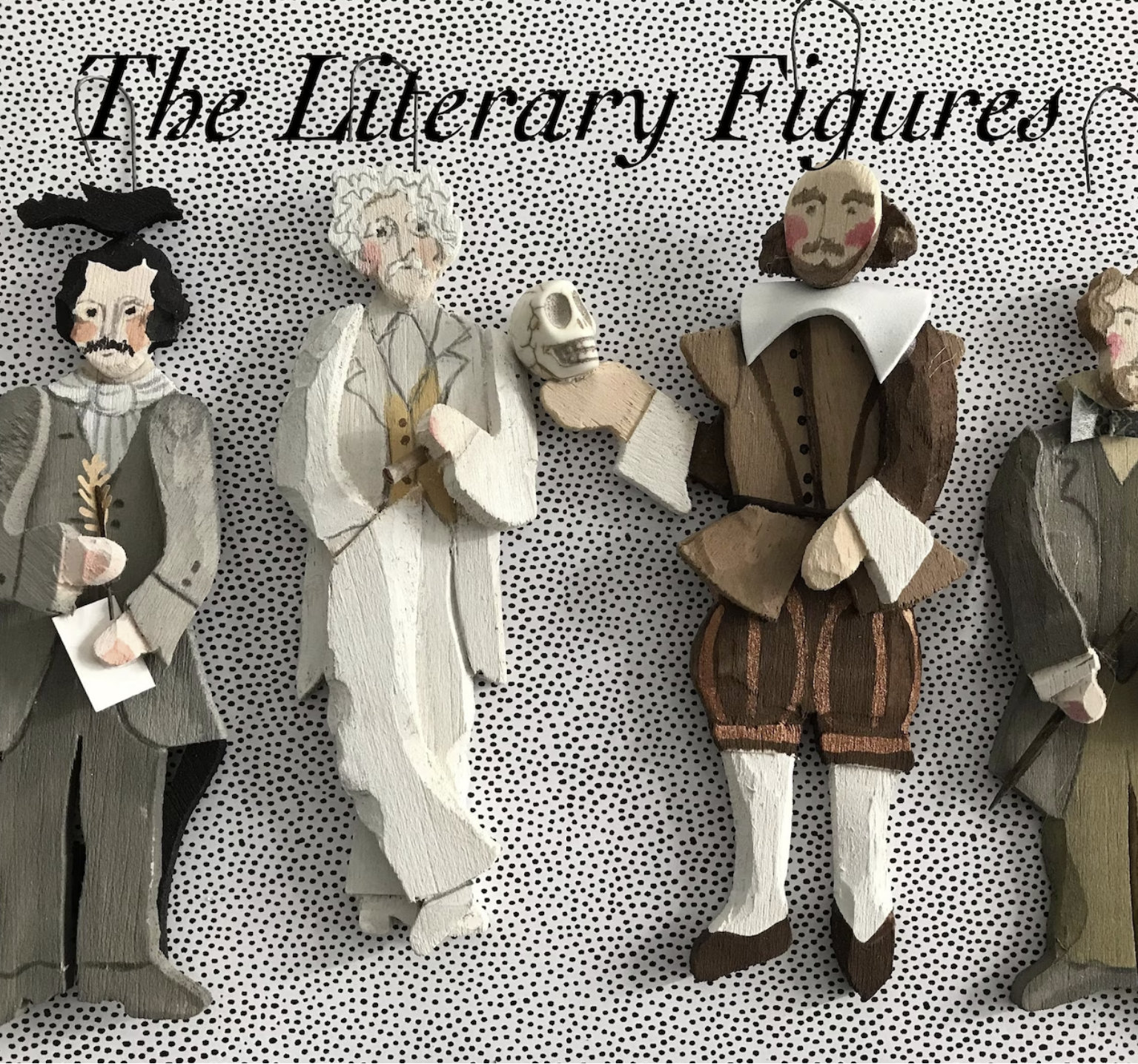 Wooden literary ornaments made to look like Edgar Allan Poe, Mark Twain, Shakespeare, and Charles Dickens. 