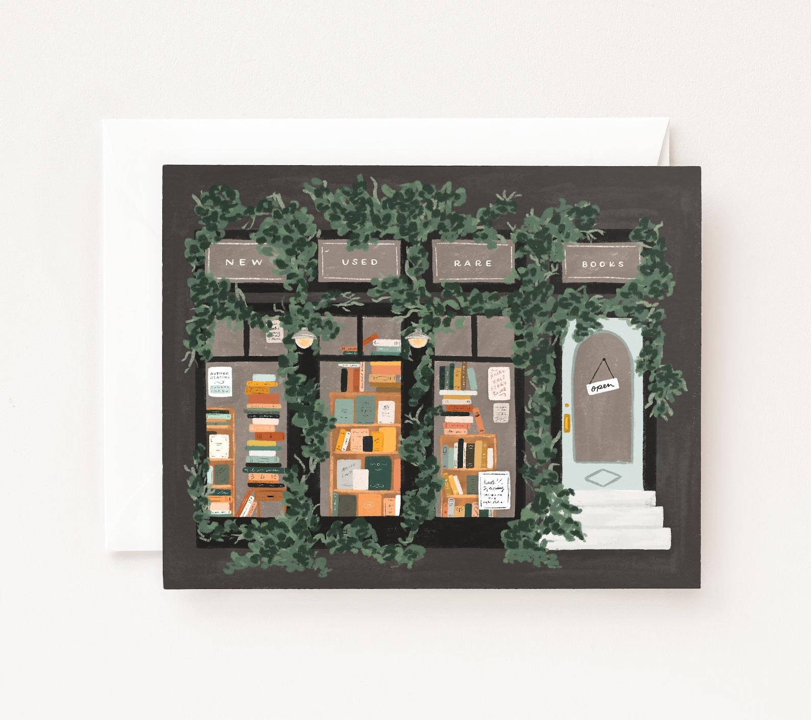 a photo of a greetings card featuring an illustrations of a bookstore viewed from the outside. The building is covered in ivy.