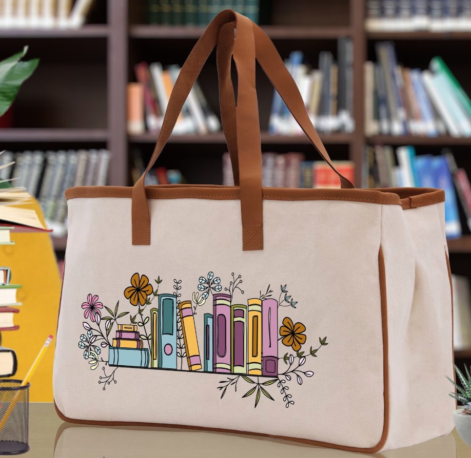 large tote bag featuring an image of books on a shelf with flowers.