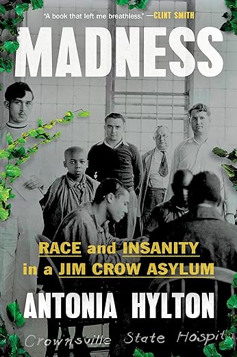 cover of Madness: Race and Insanity in a Jim Crow Asylum by Antonia Hylton; b&w photo of several white men standing with several Black men, with green ivy drawn along one edge