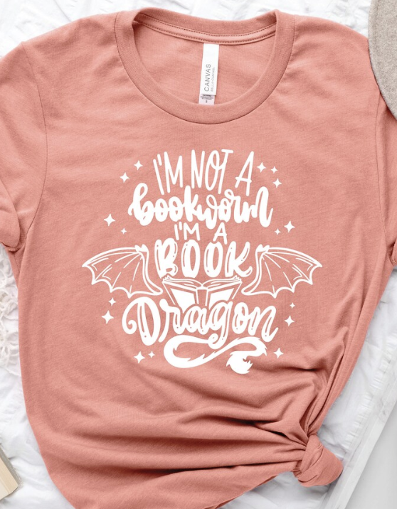 a t-shirt with the text "I'm Not A Bookworm I'm A Book Dragon" with wings around the word "dragon"