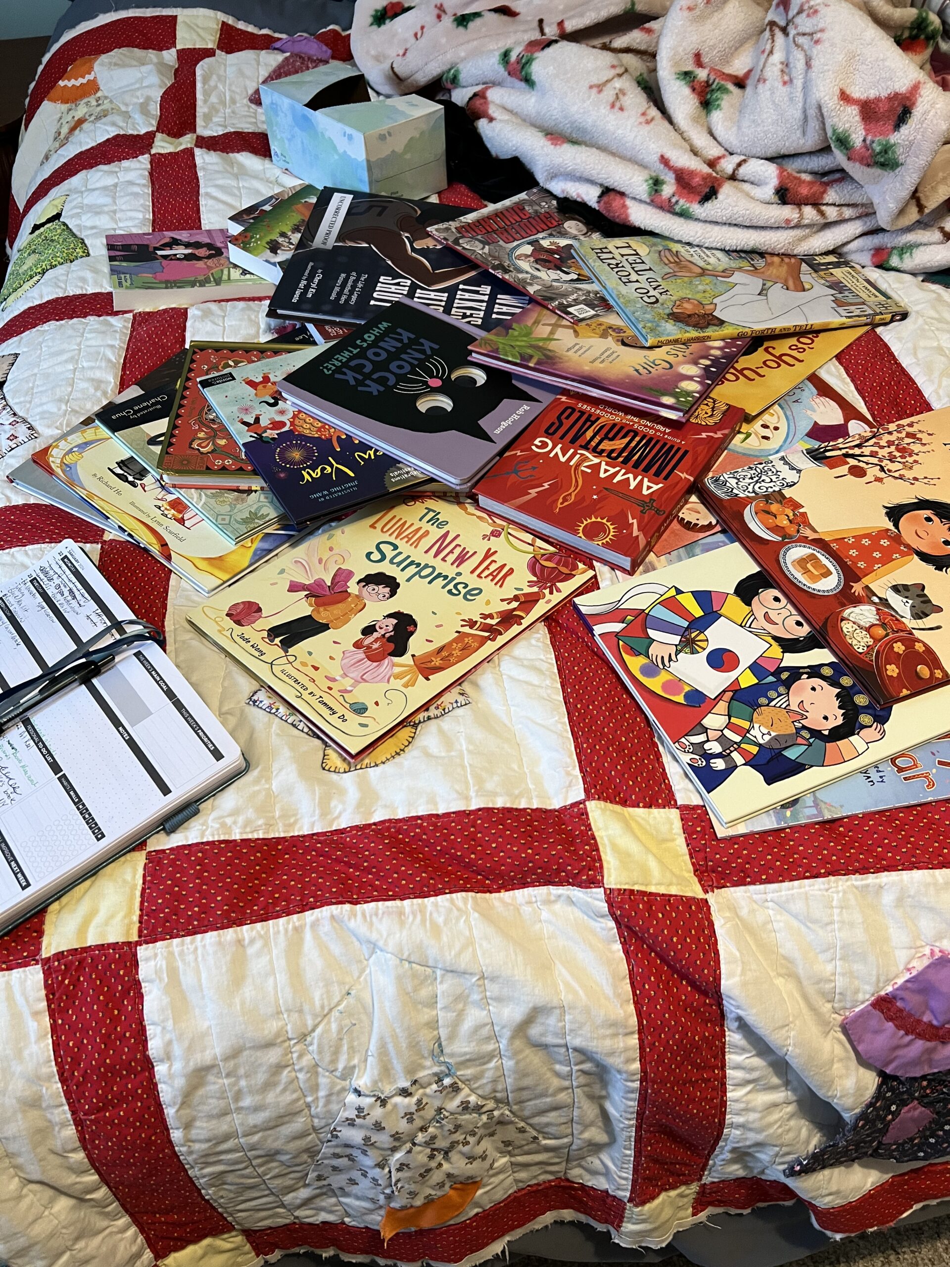 a photo of picture books spread out across a bed