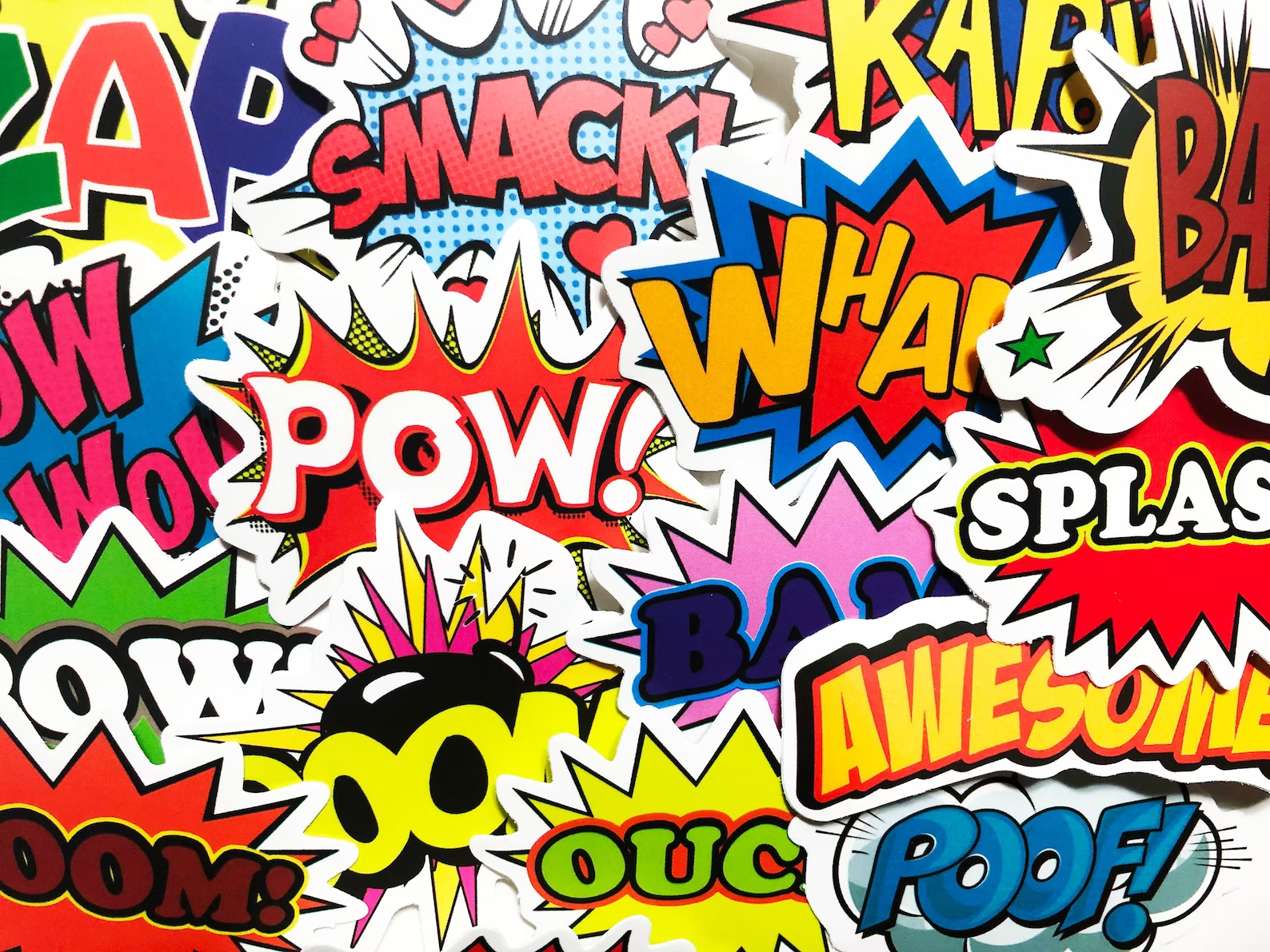 A collection of colorful stickers, each with a different onomatopoeia, such as "pow," "wham" and "smack."