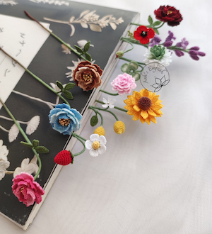 various types of crocheted flowers handmade to be bookmarks