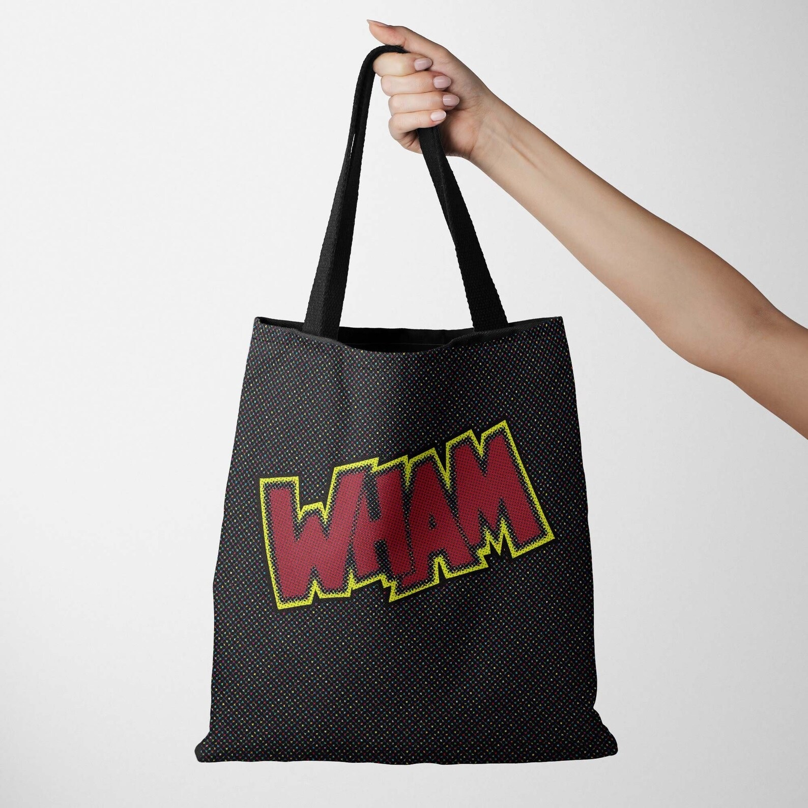 A black tote bag with the word WHAM printed across the side in red letters outlined in yellow