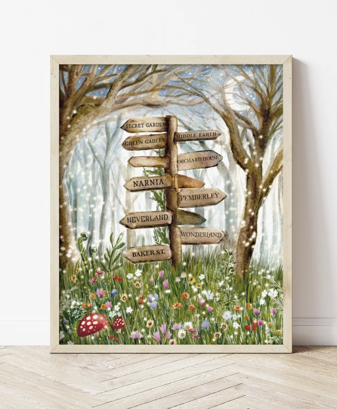 Framed watercolor painting of a woodland forest with a wooden signpost in the center featuring the names of literary locations like "Narnia" and "Middle Earth." 