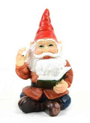 miniature gnome made of resin sitting reading a book