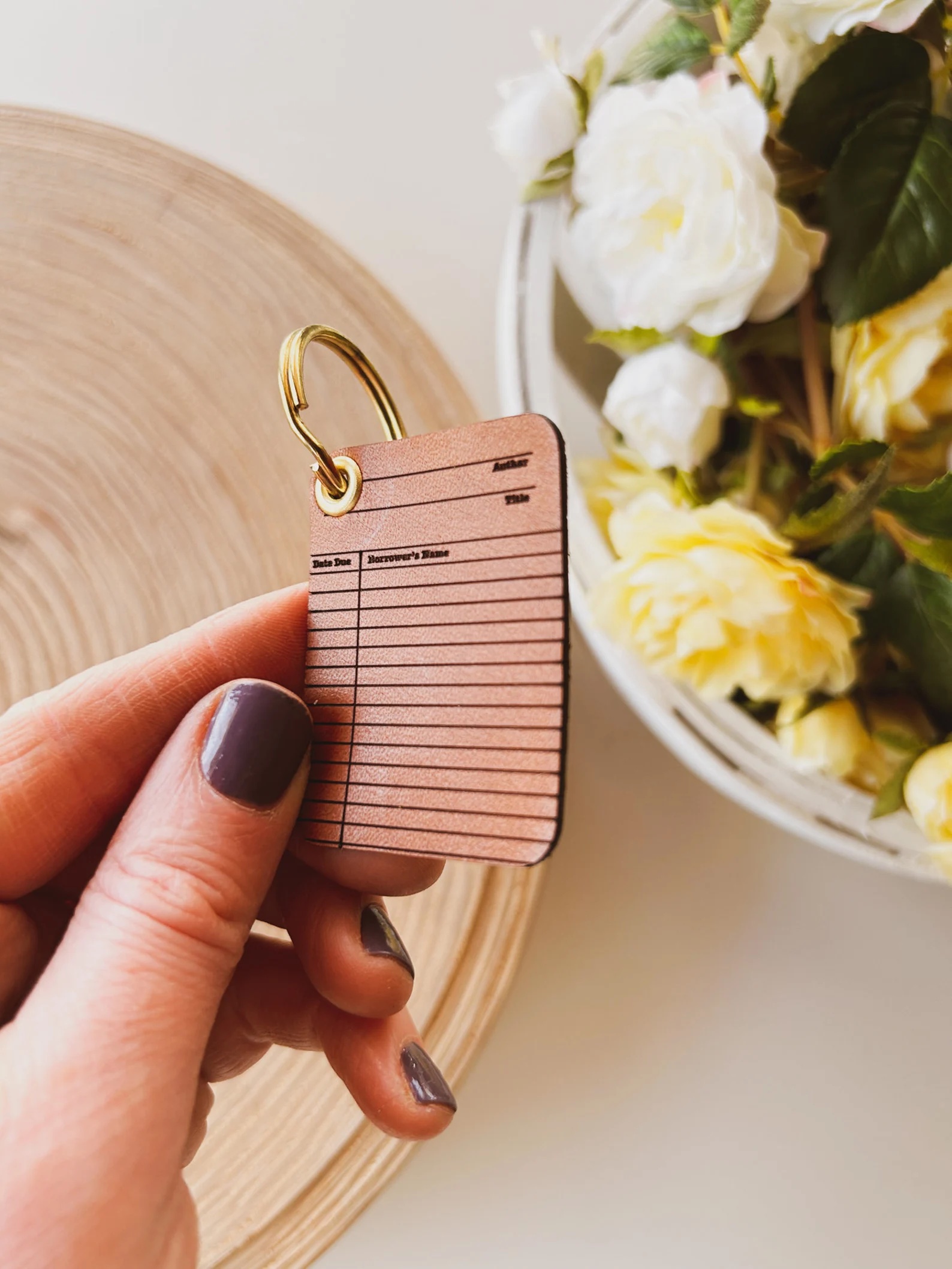 a photo of a little library card keychain made out of leather