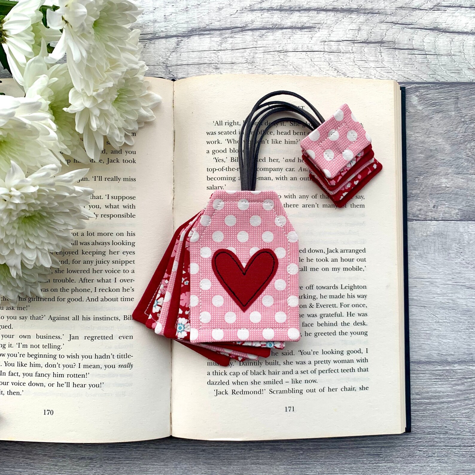 a photo of a bookmark that look like a teabag. It's made out of sewn cloth and a cord