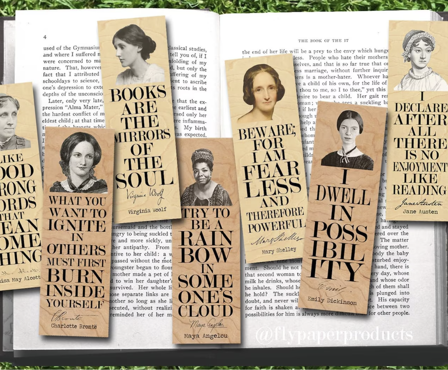 A set of seven wooden bookmarks set against an open book featuring various famous female authors with their portraits on top and quotes from them in pretty script below.