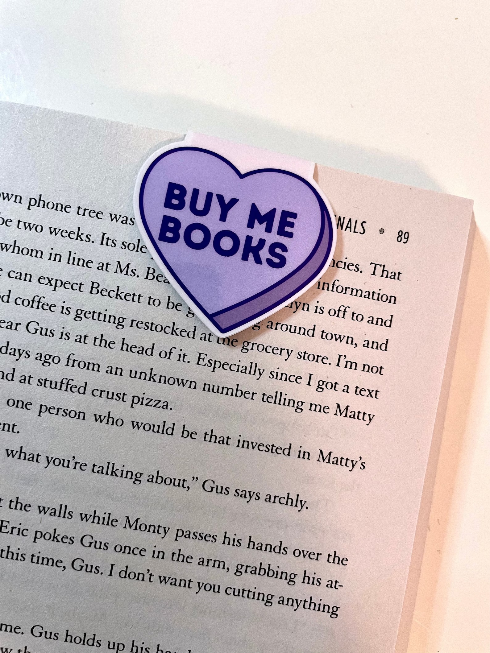 a photo of a purple candy heart bookmark that says Buy Me Books