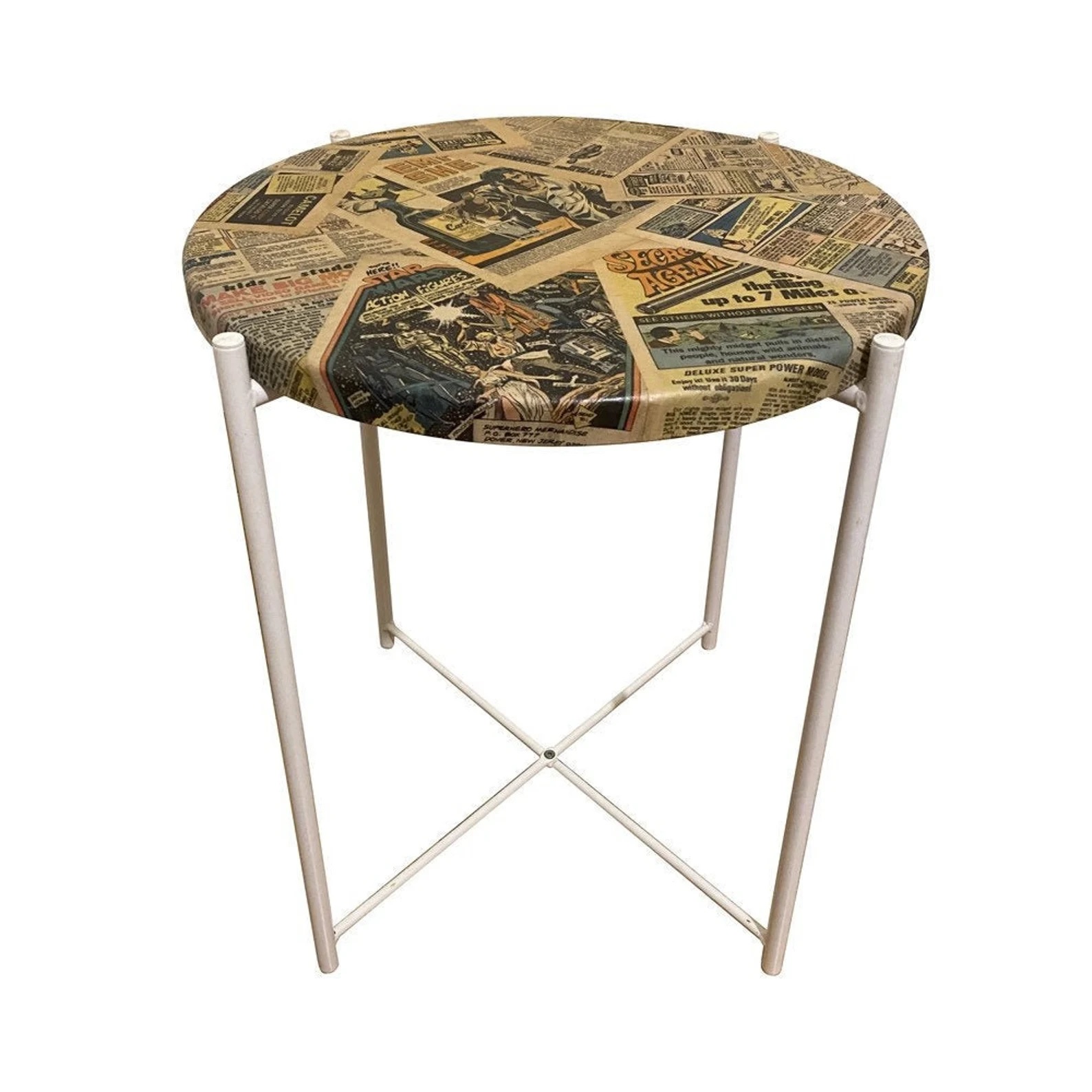 A round, four-legged side table. The top is covered with overlapping pages from old comics