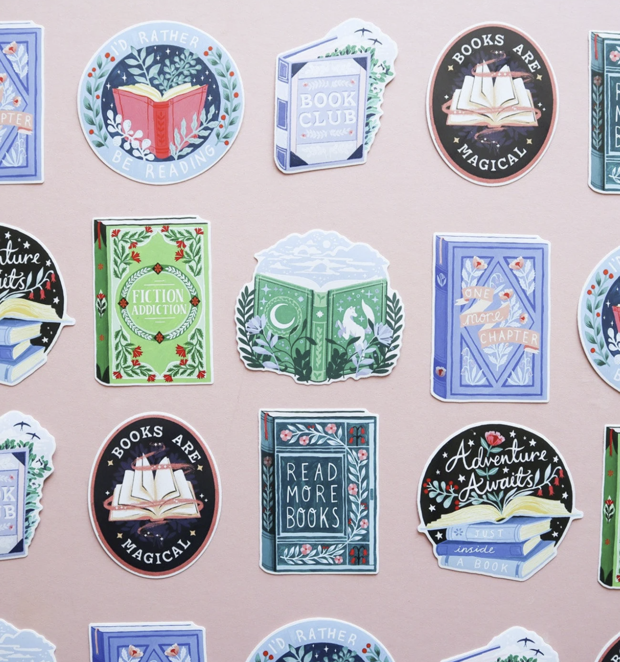 rows of bookish cute bookish stickers set against a pale pink background feature illustrated book covers, open books, and decorative book stacks