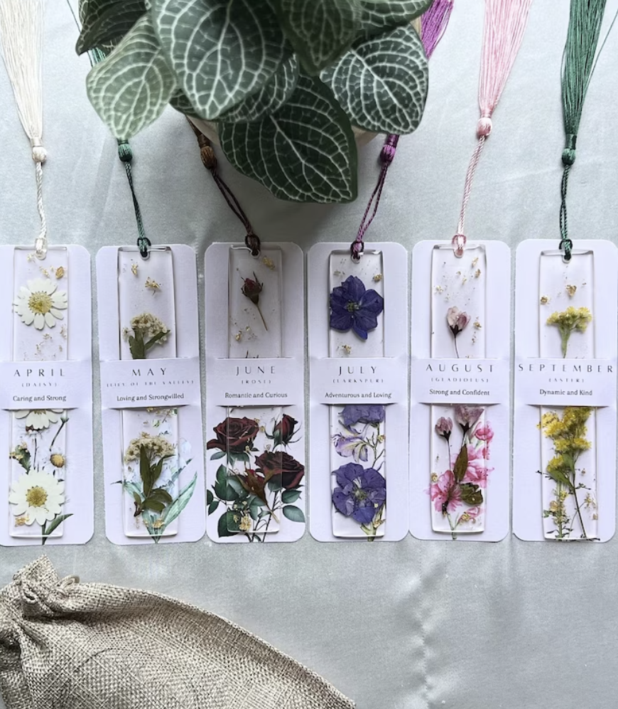 Pressed flower bookmarks featuring each month of the year's birth flower in clear bookmarks