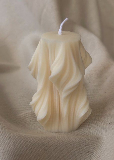 small wavy pillar candle, cream-colored