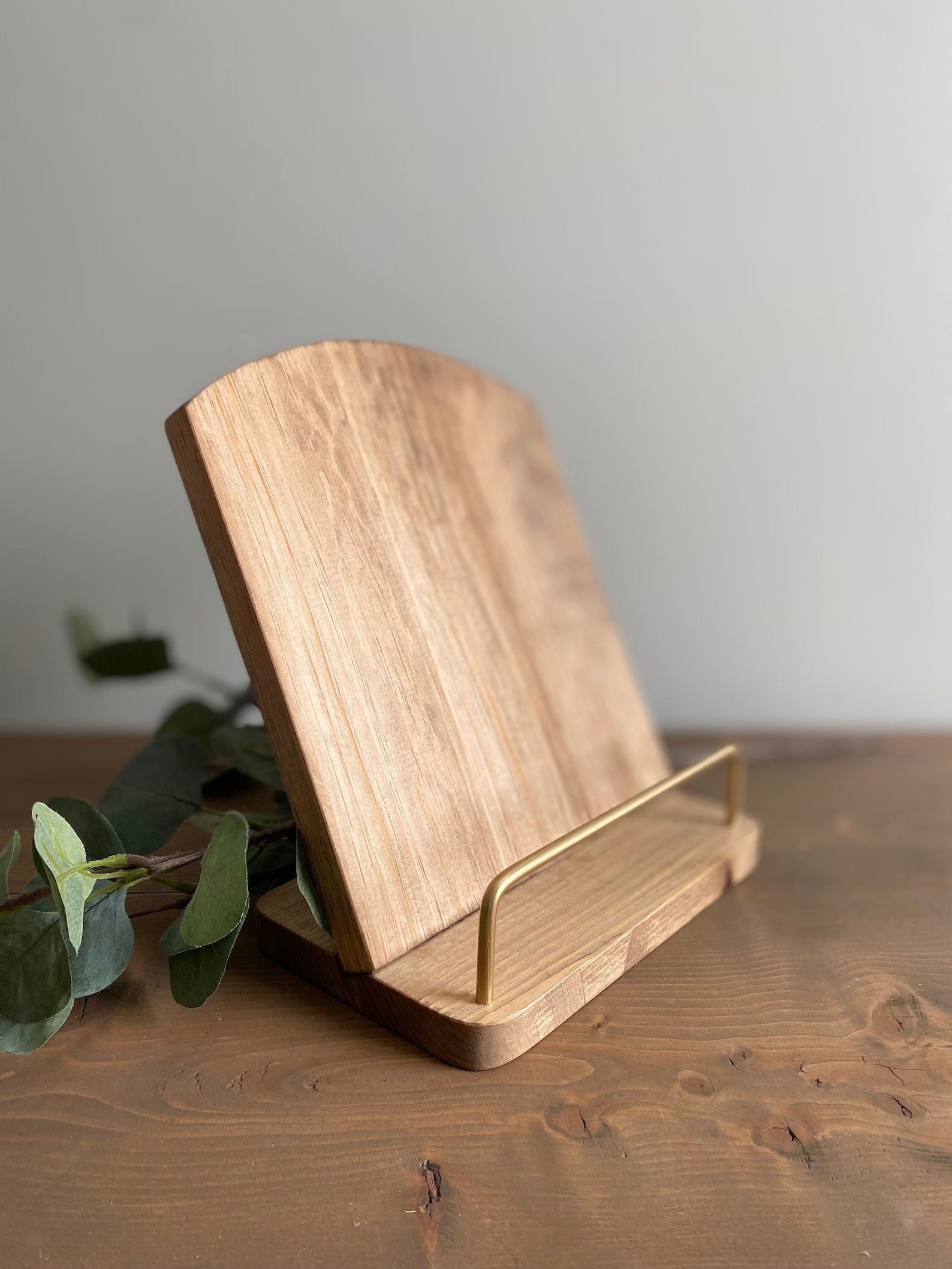 a photo of a gorgeous cookbook holder made out of stained wood